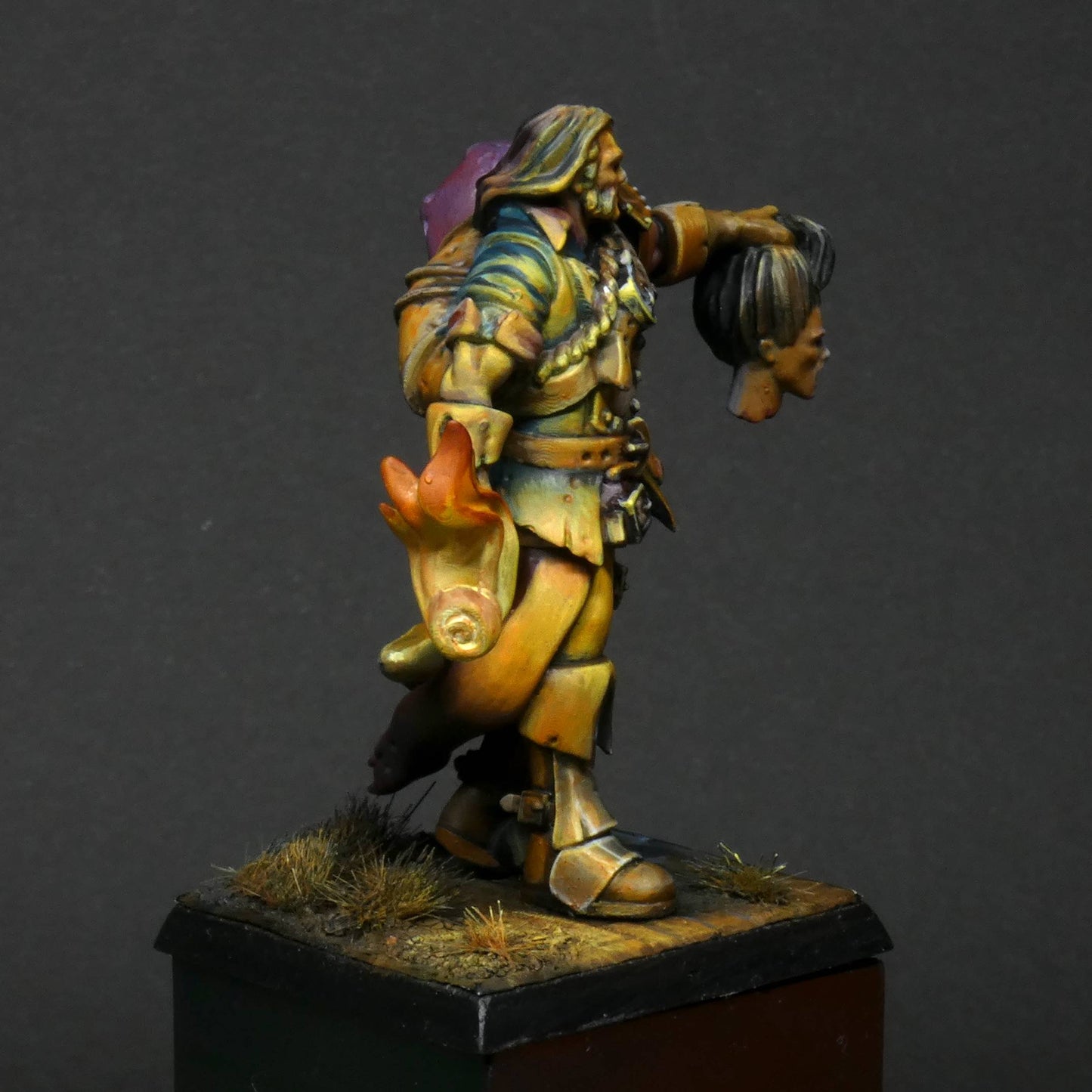 32mm scale miniature of Cristof Witchbane, a rugged witch hunter wielding a flaming torch and a severed witch's head. The model is viewed painted beautifully with excellent lighting effects from the fire of the torch.