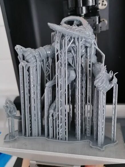 A 120mm sized 32mm scale miniature of Ifrit inspired by Final Fantasy. The model is shown on the build plate of an Epax X1 4K with all supports still attached