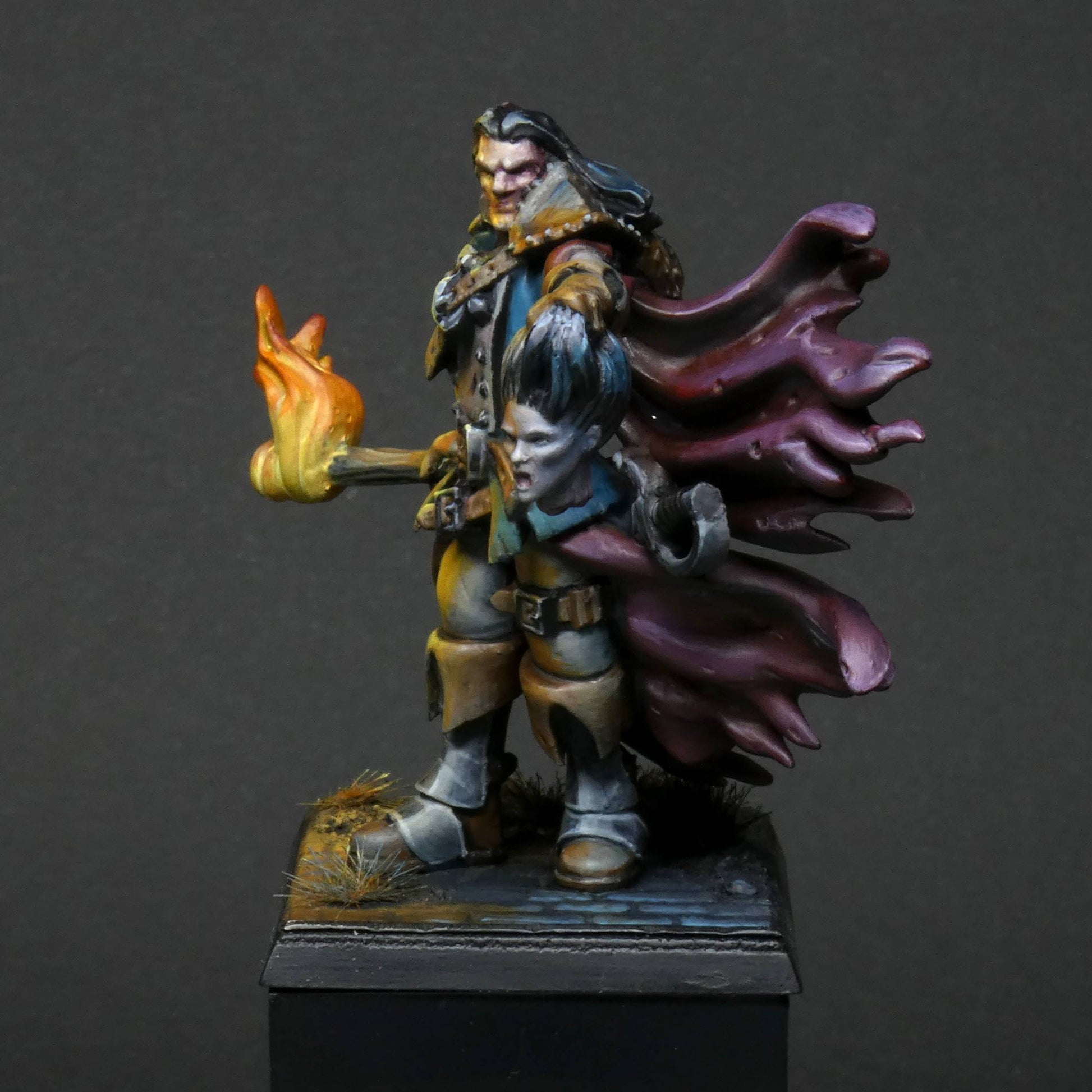 a 32mm scale miniature of Cristof Witchbane, a rugged witch hunter wielding a flaming torch and a severed witch's head.  The model is viewed painted beautifully with excellent lighting effects from the fire of the torch. 